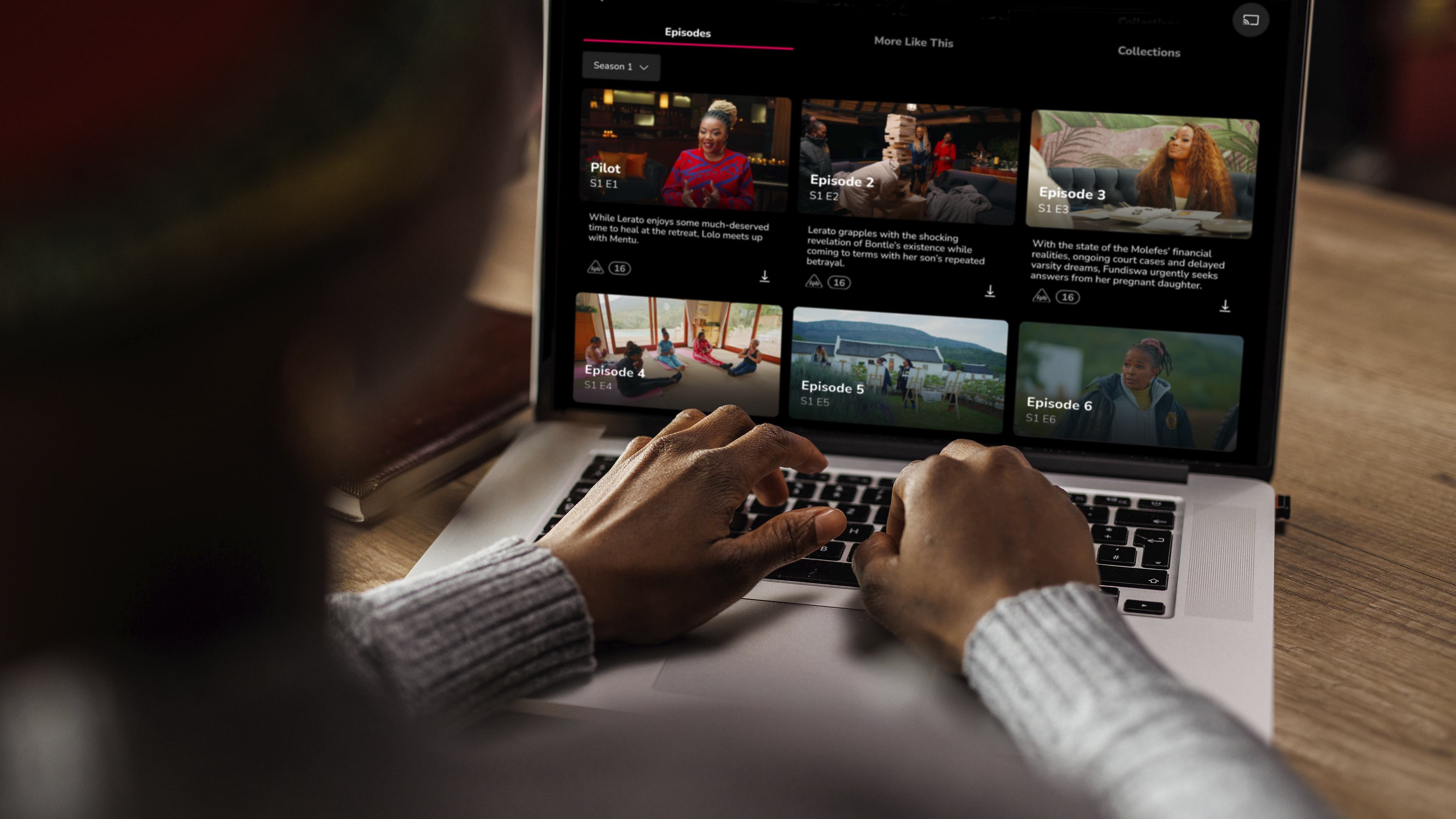Man typing on laptop showing Showmax